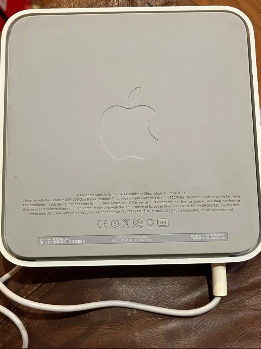 Apple AirPort Extreme base station with power supply.